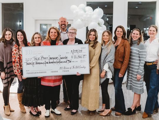 '100 Women' give check to burn survivor organization