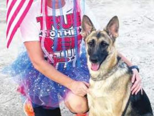 A red, white and blue jog with a dog celebration