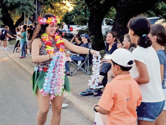 Handing out parade leis