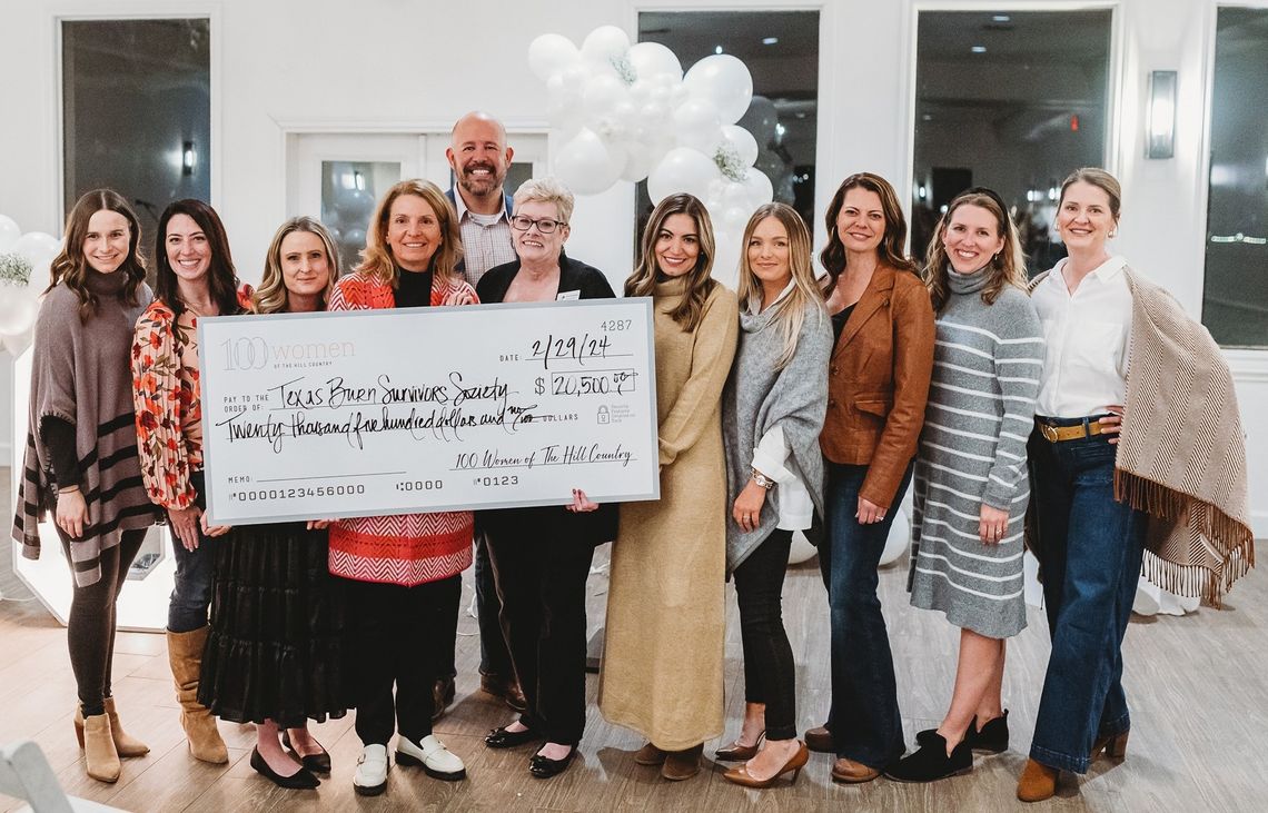 '100 Women' give check to burn survivor organization