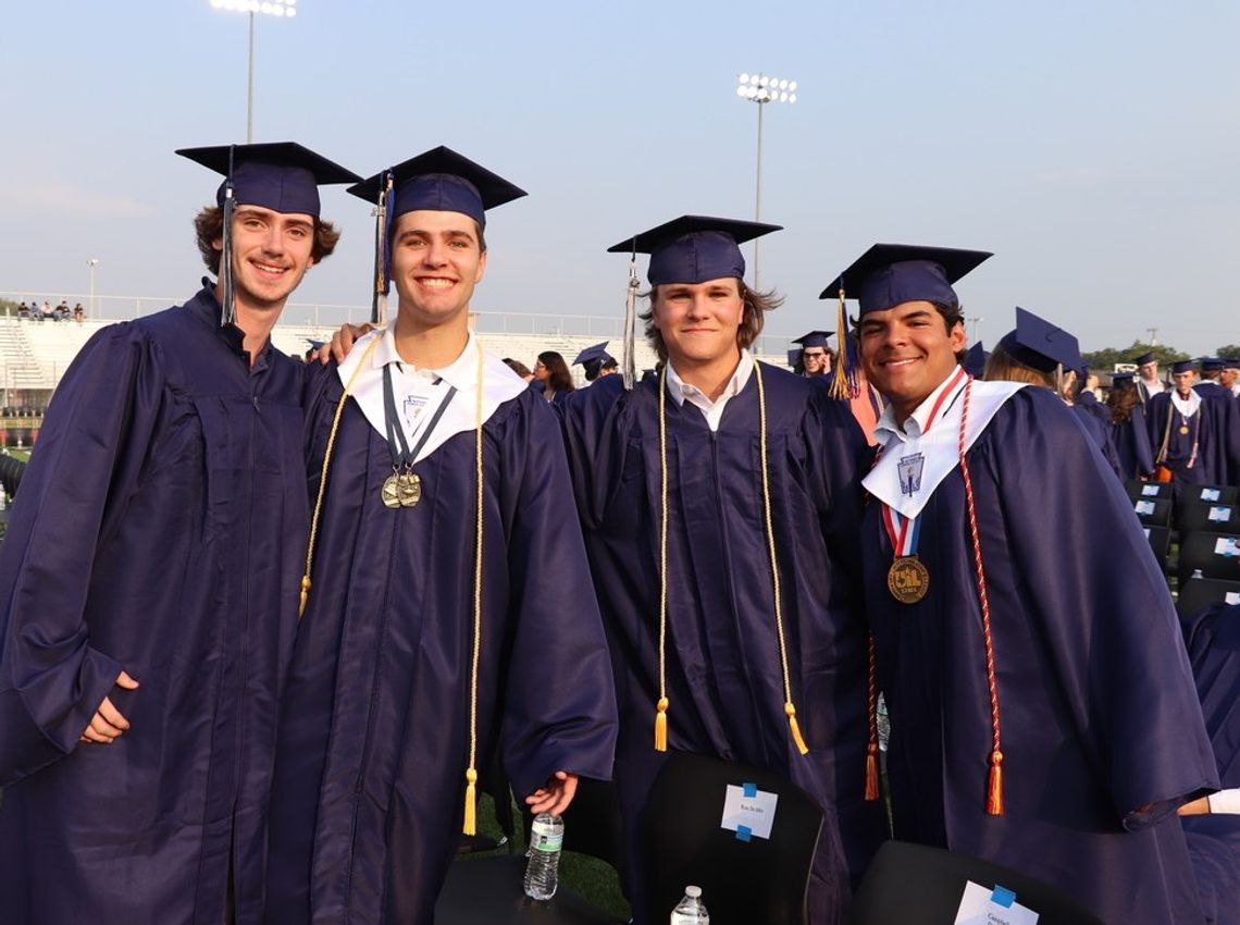 Champion seniors cross stage, turn tassels during commencement