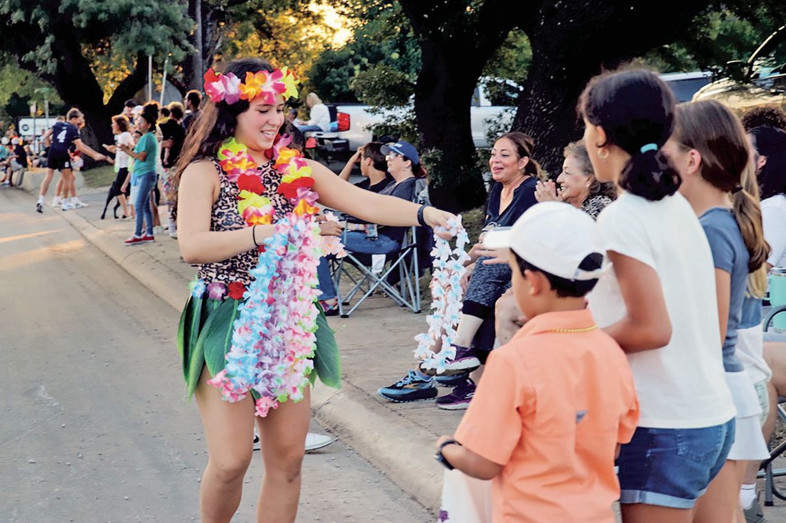 Handing out parade leis