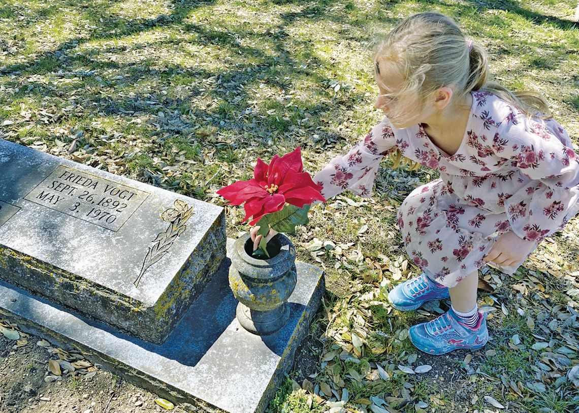 Kindergarteners tidy up wind-blown cemetery