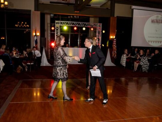 Incoming chamber board President Robb Weller congratulates Connie McFall Clark of Connie Can Write and presents her with the Ambassador Council’s Member of the Year Award.  Photo courtesy of the Greater Boerne Chamber of Commerce