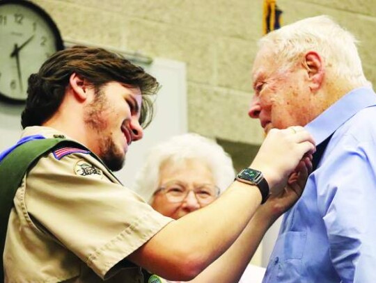 Rylan Markwardt attaches a pin to the shirt of his grandfather, Roy Markwardt, during his ceremony. Also pictured is his grandmother, Lou Markwardt. Star photo by Zachary-Taylor Wright