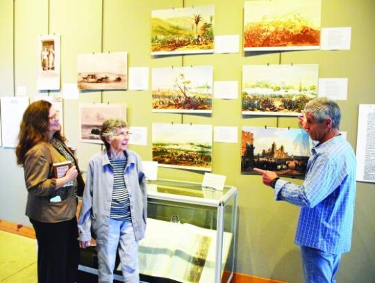 Braden Moon talks about the Patrick Heath Public Library's Kendall of Kendall exhibit to Suzanne Young, secretary of the Kendall County Historical Commission, and Martha Hawkins, a member of the Boerne Area Historical Preservation Society. Star photo by Keith E. Domke