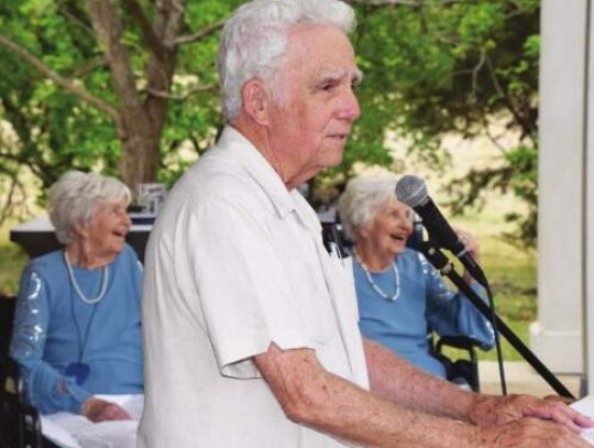 Brent Evans shares a humorous moment during last Saturday’s Herff twins 100th birthday celebration, much to the delight of Juanita Herff Chipman and Carolyn Herff Kennon, pictured in the background. Star photo by Keith E. Domke