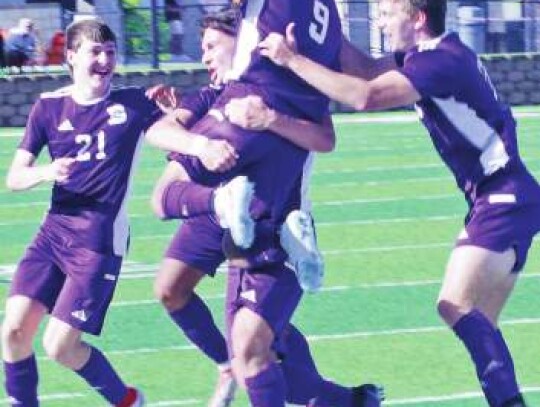 Adrian Cuervo (9) gets a lift from Landon Murphy and other teammates after scoring a goal at state. Star photo by Kerry Barboza