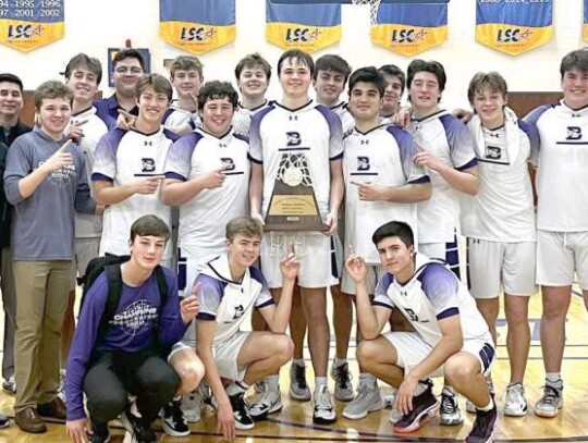 Members of the Boerne boys basketball team pose with the Region IV-4A championship trophy they won to make it to the 4A state tournament for the second straight season. </br> Submitted photo