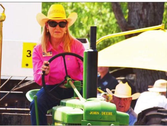 Republican Precinct 2 Kendall County Commission candidate Andra Wisian drives an antique tractor last Saturday as she participates in an antique tractor pull competition. Star photo by Keith E. Domke