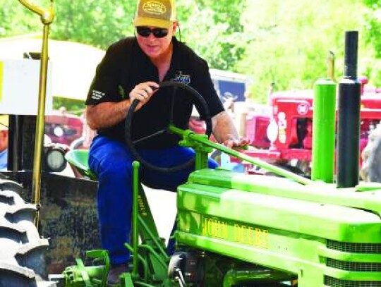 Republican Kendall County judge candidate Chris Taylor drives an antique tractor last Saturday as he participates in an antique tractor pull competition. Star photo by Keith E. Domke