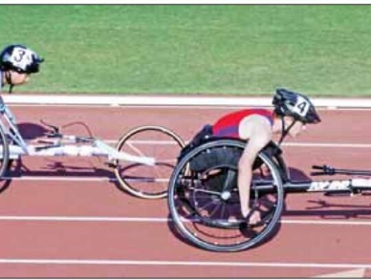 Champion’s Ephraim Tonn-Bourg (left) competes in one of his two wheelchair events at last week’s state meet. He finished third in the 100 wheelchair. </br> Star photos by Kerry Barboza