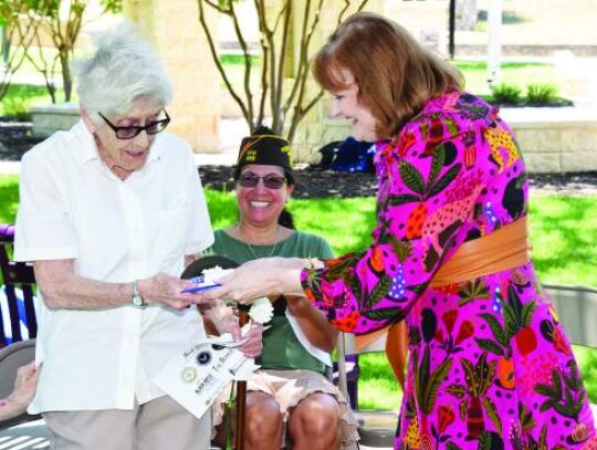 Dixie Morrow, right, delivers the first piece of the cake to fellow Air Force veteran Ruth Elizabeth “Bettie” Edmonds, who at age 91 was recognized as the oldest female veteran in attendance at Sunday's ceremony at Veterans Plaza. Star photo by Keith E. Domke