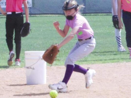 One of the campers chases down a grounder and gets ready to backhand it during one of the drills. 