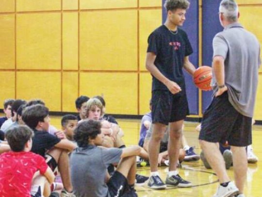 Boerne High School boys basketball coach Kimble McHone gets Champion graduate Jesse Peart to do a demonstration in front of some of the campers. </br> Star photo by Kerry Barboza