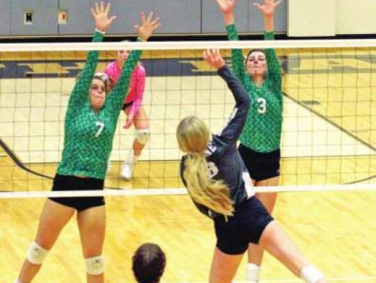 Ryleigh Jones (8) hits the ball over the net as McKenna Mann (5) watches during Boerne’s playoff match.