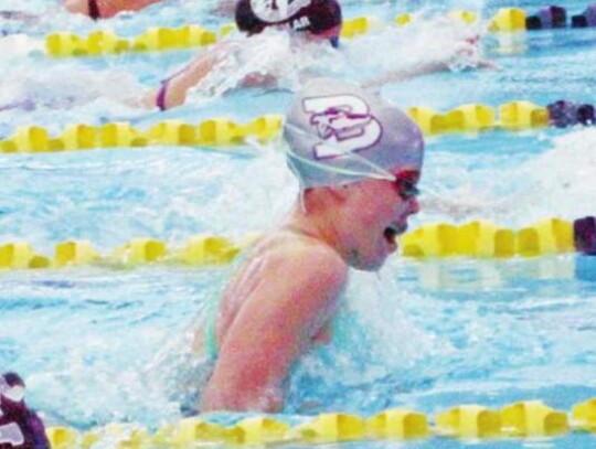 Kiali Cunningham competes for the Greyhound swim team at the district meet.