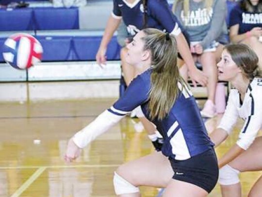 Champion’s Marissa Drange receives the ball for the Lady Chargers as her teammates watch.