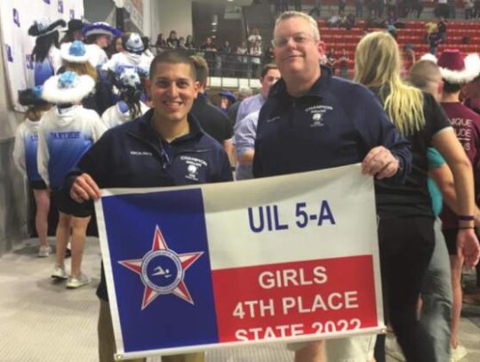 Champion swim coaches Alberto Escalante and Mike Gillette pose for a photo after the girls team finished 4th at state for their highest team finish ever.