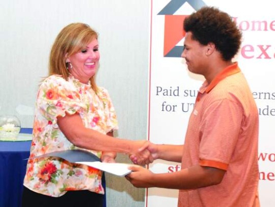 Elijah Marshall, who interned at Westward Environmental this summer, receives a certificate &amp; handshake from Boerne Kendall County Economic Development Corporation President and CEO Amy Story during Thursday’s Home to Texas reception.