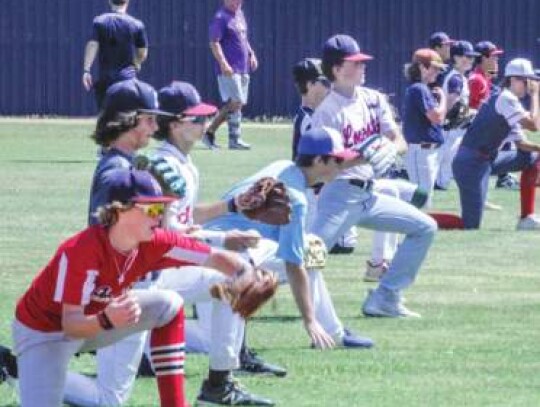 The campers go through a throwing drill on one knee as BHS coach Bill Merrell and Chargers coach Ben Woodchick watch. </br> Star photo by Kerry Barboza