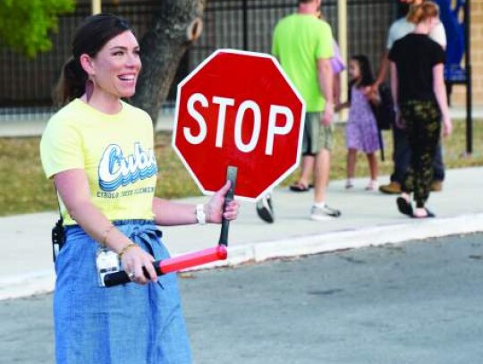 Front office employee Melanie Bostic pulled double duty on Wednesday as she served as the crossing guard in front of the school. 