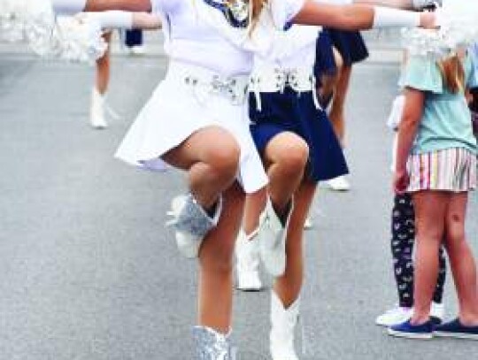 Champion High School’s Camryn Leslie performs a dance routine as she and her fellow Charms walk the Kendall County Fair Parade route on Saturday morning. Star photo by Keith E. Domke