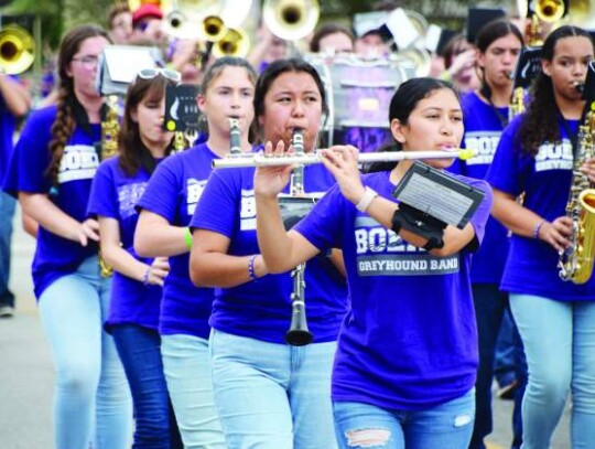 Melissa Salgado, Barbara Corchado and Katelyn Merritt, from front right, play their instruments with their fellow Boerne High School band members as they march along Main Street during Saturday’s fair parade. Star photo by Keith E. Domke