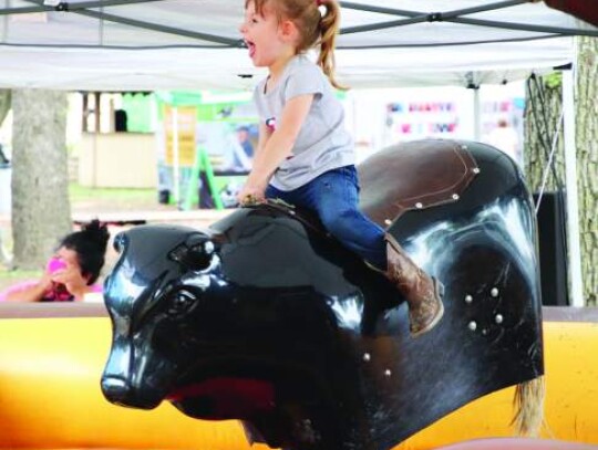 Ella managed held onto the mechanical bull at the county fair Sunday, avoiding a toss-off during her ride. Star photo by Zachary-Taylor Wright