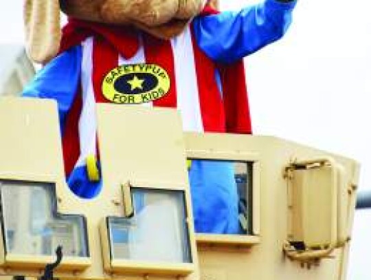 Safety Pup, the Kendall County Sheriff’s Office mascot, waves to the fair parade crowd. Star photo by Keith E. Domke