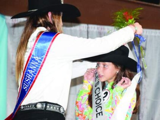 Lillie Vogt, the Kendall County Fair Association’s junior miss for 2022-23, reacts as outgoing Queen Sushanna Cobb places the People’s Choice Award sash around her neck Thursday night. Vogt won that honor besides being named the fair’s junior miss. Star photo by Keith E. Domke