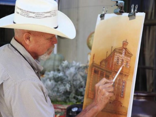 Comfort local Mike Martin puts the finishing touches on a piece of work at the annual Comfort Art Festival Saturday. Photos by Zachary-Taylor Wright