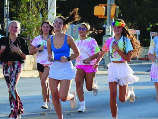 Members of the Boerne High Yoga Club were all smiles as they sprinted down Blanco Road between parade floats and vehicles. From left: Allie Kile, Ava Barrows, Averi Hughes, Anna Grace Loeb, Nicole Hernandez, Caris Patrick, Hope Jackson and Makayla Vasquez.