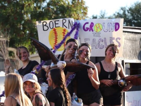 The Boerne Greyhounds softball team was chalk full of school spirit at the Boerne High Homecoming Parade Monday as they flashed signs and held up plastic eagles. Standing: Heidi Maytum, Taryn Madlock, Cameron Cooper and Isa Renteria. Seated: Kendall Murphy, Olivia Langer and Ava Nieto.