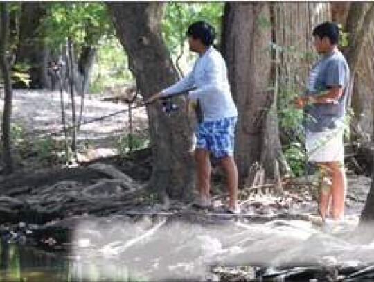 Alex Pineda and Raymond Quintana fished the Cibolo Creek Monday afternoon, getting excited when Pineda saw a large bass.