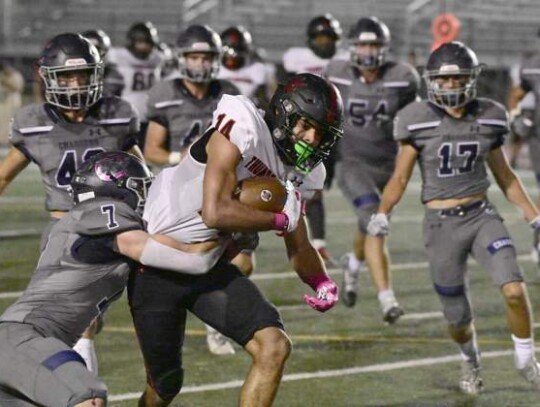 Champion’s Evan Kuhl (7) works on bringing down Wagner’s Jeremiah Chery (14) during Friday’s football at Boerne ISD Stadium. </br> Star photos by Chris Tilton