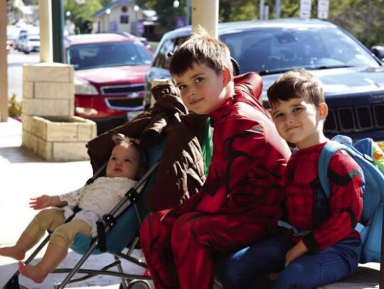 Merci, Roman and Kai Gould take a break outside of Daly Finds Resale Boutique during the Boerne Trick or Treat Trail Sunday.