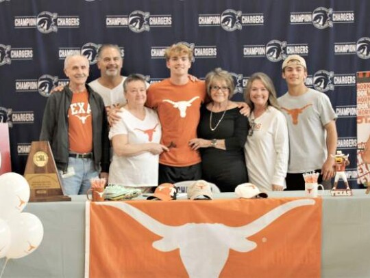 Champion’s Brock Lewis signed a national letter of intent to compete in track and field at the University of Texas at Austin. Champion’s Brock Lewis signed a national letter of intent to compete in track and field at the University of Texas at Austin.