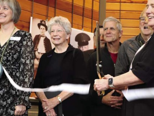 The heads of Patrick Heath Public Library snip the ribbon celebrating the operational status of their historical database Thursday afternoon.