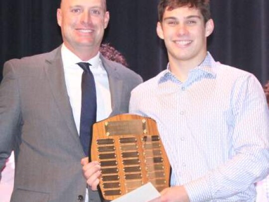 Coach Blane Ellis handed out the Most Valuable Defensive Player Award to Gage Goldberg.