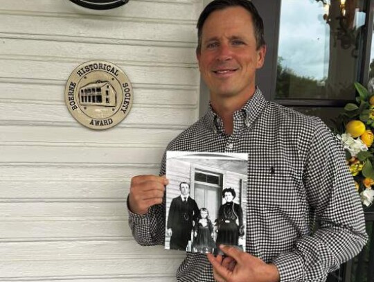 Sam McGee, owner of Crestmont Private Wealth, stands with the award given to him by the Boerne Area Historical Preservation Society for his preservation of a historical home at 604 S. Main St. Photo by Zachary-Taylor Wright