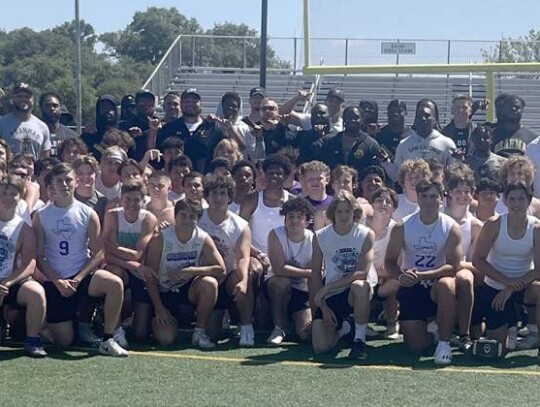 Members of the Boerne High football team pose for a photo with members of the San Antonio Brahmas XFL team during a recent visit. </br> Star photo by Kerry Barboza