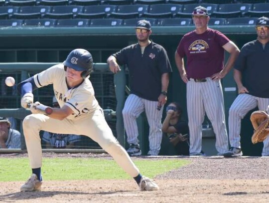 Sam Miller lays down a bunt for the Chargers against Rouse at Wolff Stadium during the regional championship round. </br> Star photo by Chris Tilton