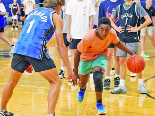 Former Greyhound player Koen Wolff works with the campers on one of the drills to help them with their left-hand dribble. </br> Star photo by Kerry Barboza