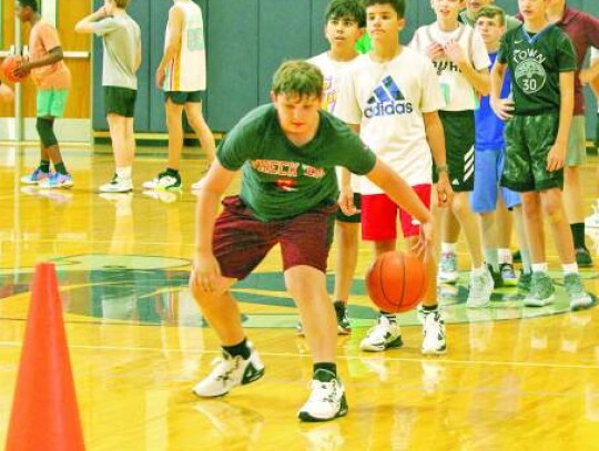 Campers work on their dribbling skills, going around cones set up on the gym floor. </br> Star photo by Kerry Barboza