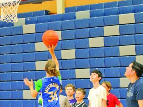 Champion assistant coach Jaime Lira watches as the youngsters work on a shooting drill. </br> Star photo by Kerry Barboza