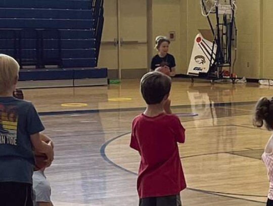 Geneva boys basketball coach Julius McNeal and helpers work with some of the campers as they go through some drills. </br> Submitted photo