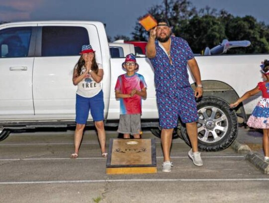 The Fey family, of Boerne, plays cornhole during Independence Day festivities at Samuel V. Champion High School.