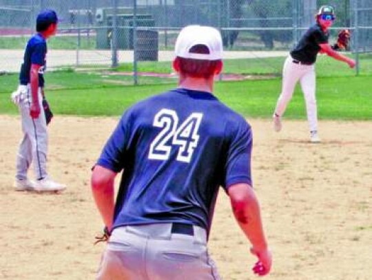 A throw to first base gets a runner at first base during one of the scrimmages held at camp. </br> Star photo by Kerry Barboza