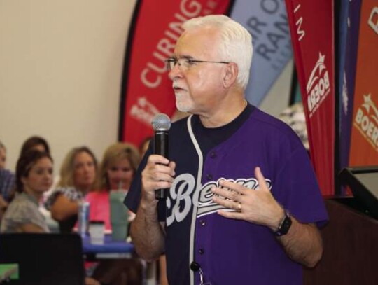 Boerne Schools Superintendent Dr. Thomas Price wears a half-Boerne Greyhound-half Boerne Champion Chargers jersey during the district’s new teacher orientation meeting Monday. Courtesy photo